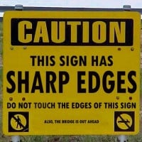 Caution. This Sign Has Sharp Edges. Do Not Touch the Edges of This Sign. Also,